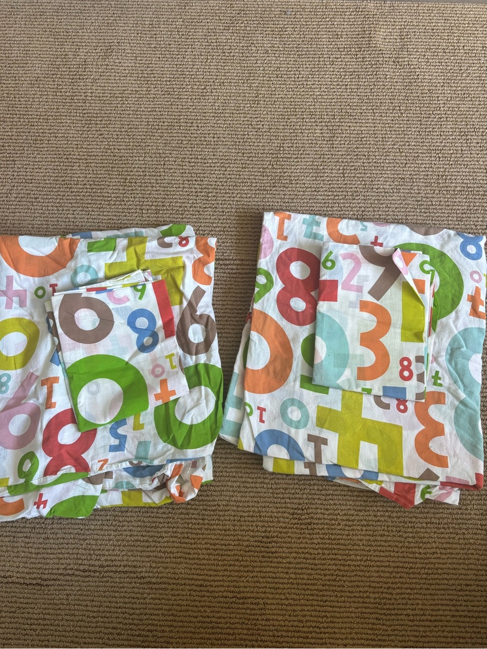Two ikea Britten nummer duvet sets, shams unused